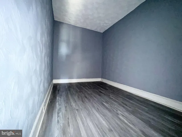 a view of wooden floor in a hallway