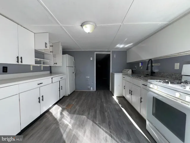 a kitchen with cabinets and sink