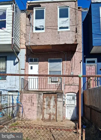 a view of a brick house with many windows