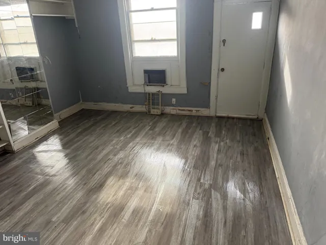 a view of a room with wooden floor and window