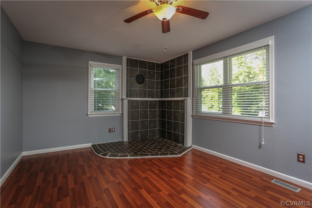 14104 South Hackberry Road Chester, VA 23836 - Photo 15 of 27 a view of a room with window a ceiling fan and wooden floor