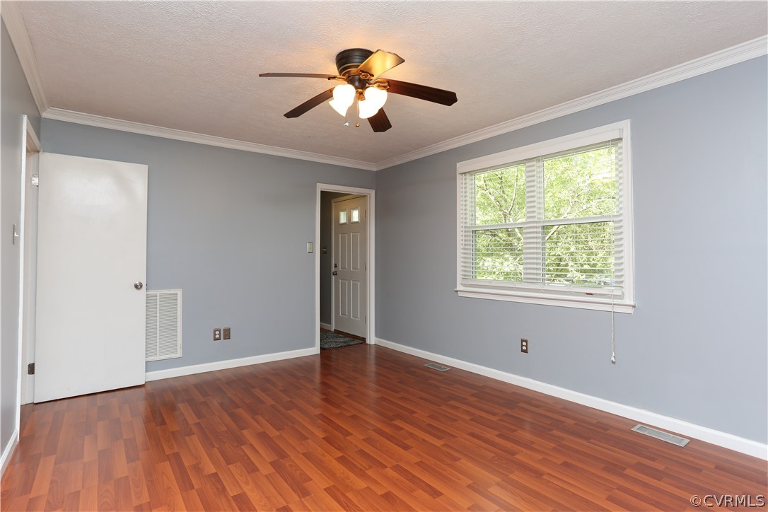 14104 South Hackberry Road Chester, VA 23836 - Photo 20 of 27 a view of an empty room with wooden floor and a window