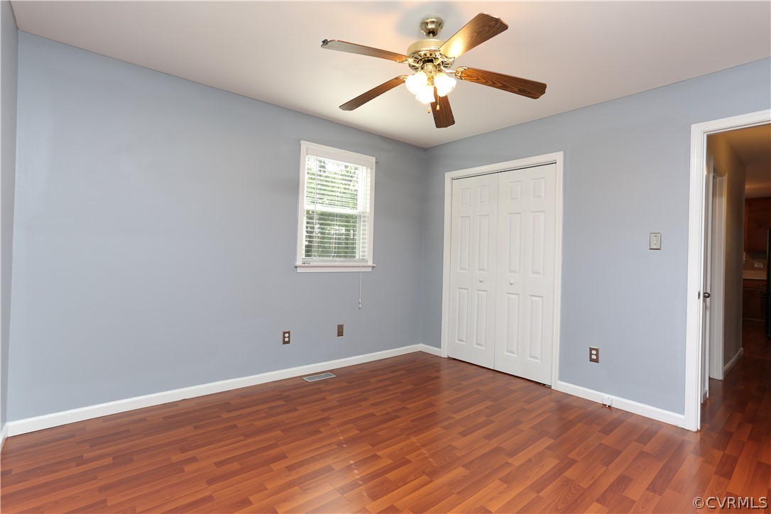 14104 South Hackberry Road Chester, VA 23836 - Photo 22 of 27 a view of an empty room with wooden floor and a window