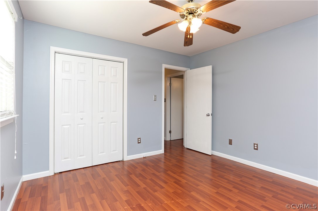 14104 South Hackberry Road Chester, VA 23836 - Photo 23 of 27 an empty room with wooden floor and windows