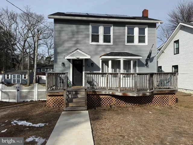 a view of a house with wooden deck
