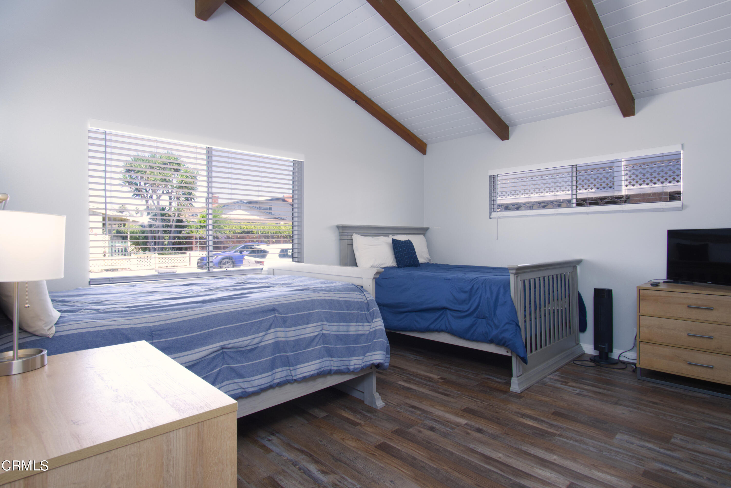 5230 Beachcomber Street Oxnard, CA 93035 - Photo 2 of 13 a bedroom with a bed and wooden floor