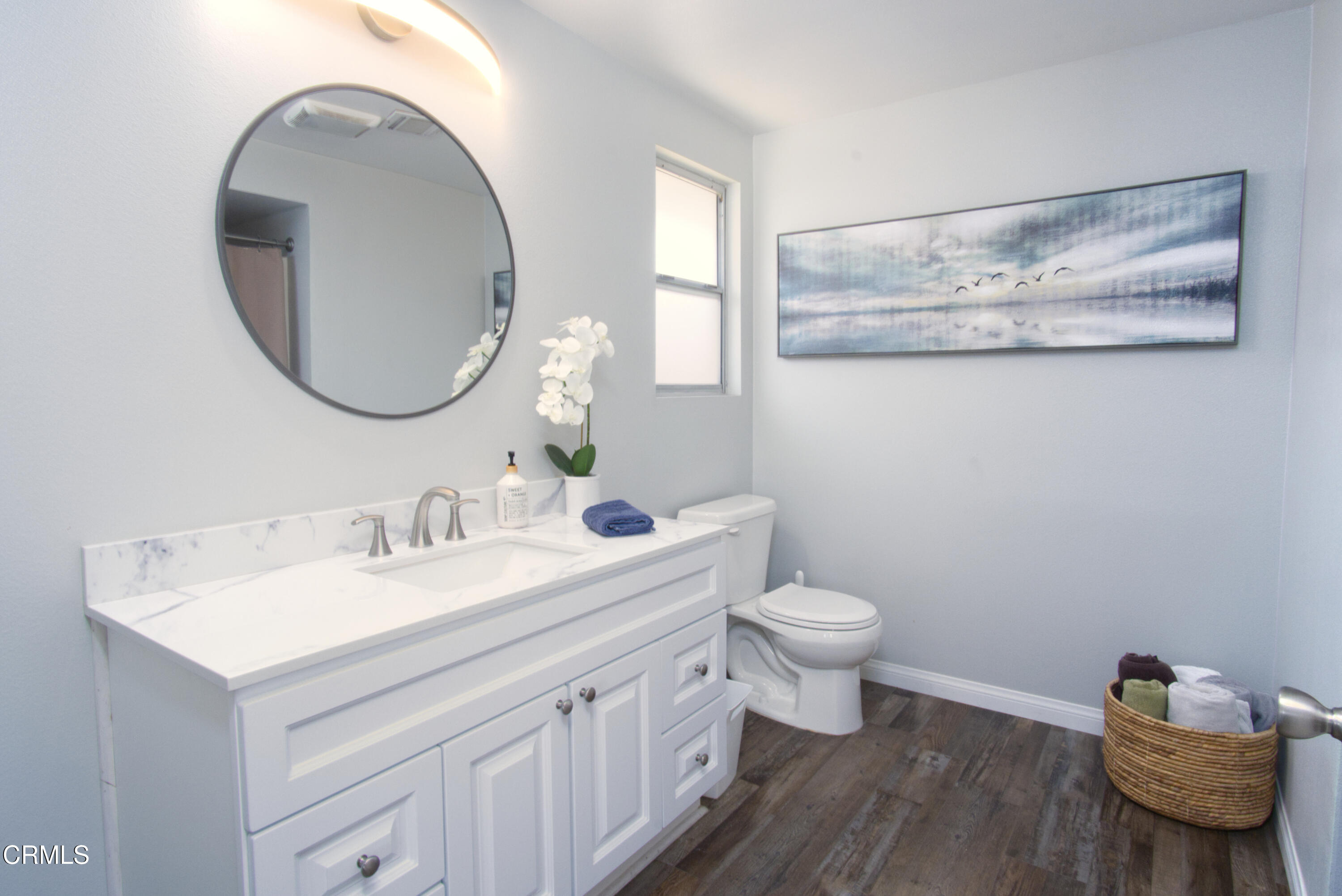 5230 Beachcomber Street Oxnard, CA 93035 - Photo 3 of 13 a bathroom with a toilet a sink and a mirror
