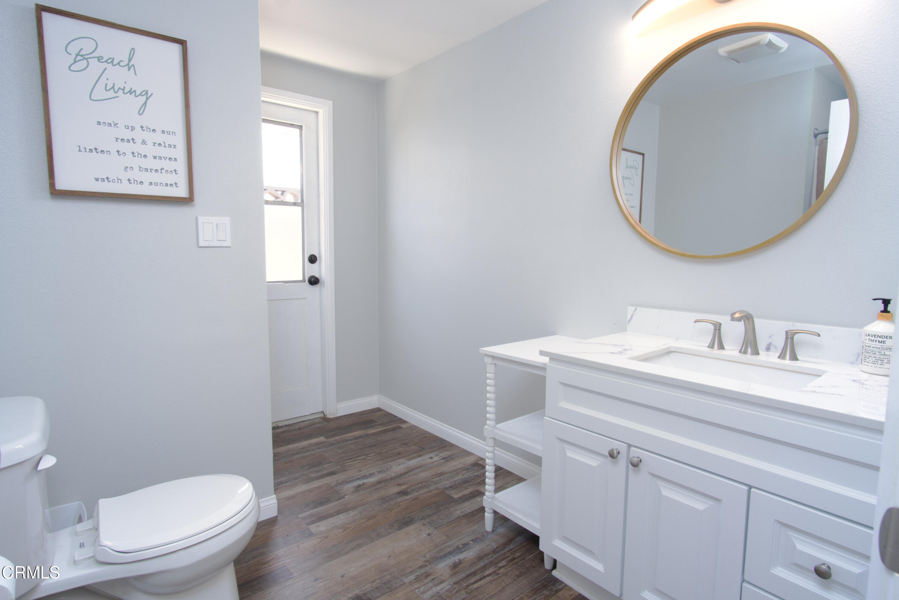 5230 Beachcomber Street Oxnard, CA 93035 - Photo 6 of 13 a bathroom with a granite countertop toilet a sink and a mirror