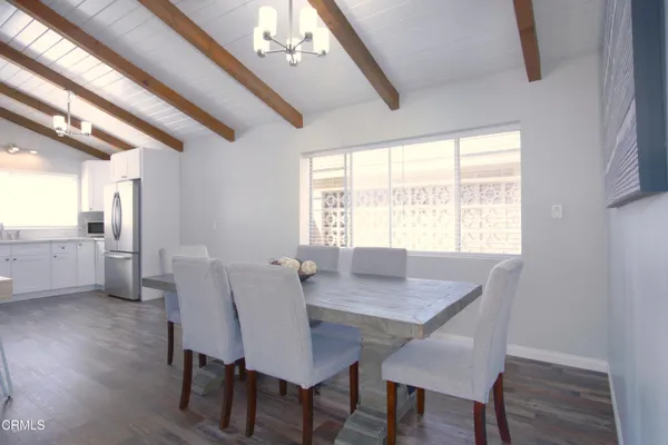 a view of a dining room with furniture and window