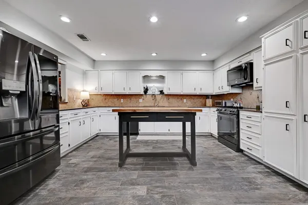 a kitchen with refrigerator cabinets and microwave