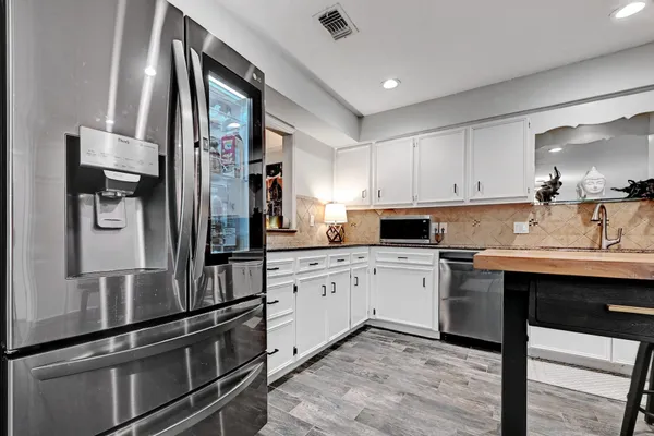 a kitchen with a sink stainless steel appliances and cabinets