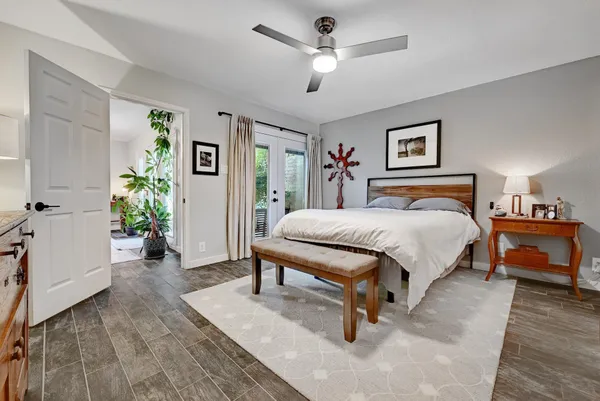 a bedroom with a bed and a chandelier