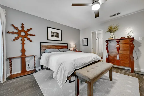 a bedroom with a bed and a chandelier