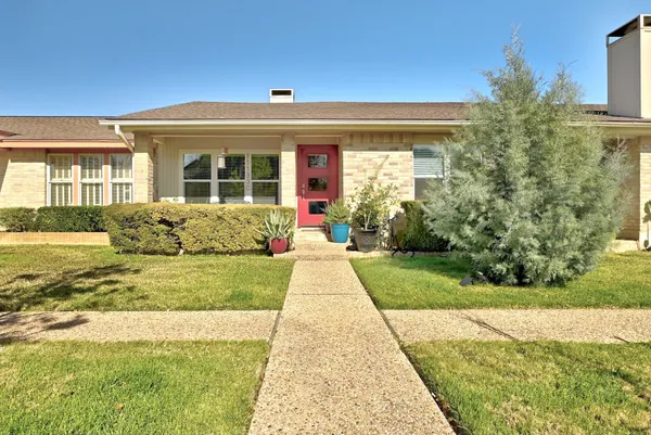 a view of a brick house with a yard