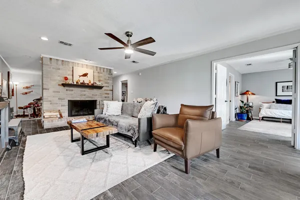 a living room with furniture a fireplace and a flat screen tv