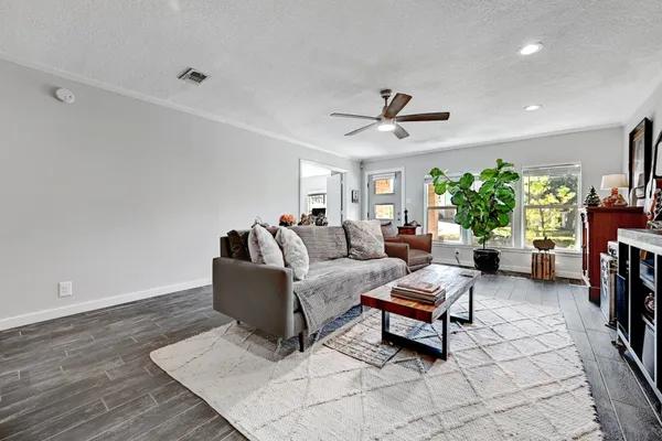 a living room with furniture and a ceiling fan