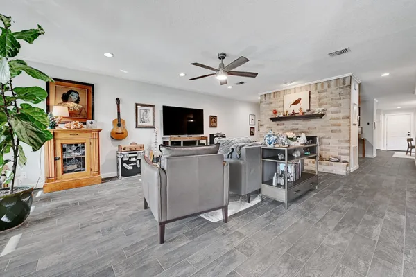 a view of a livingroom with furniture and a flat screen tv