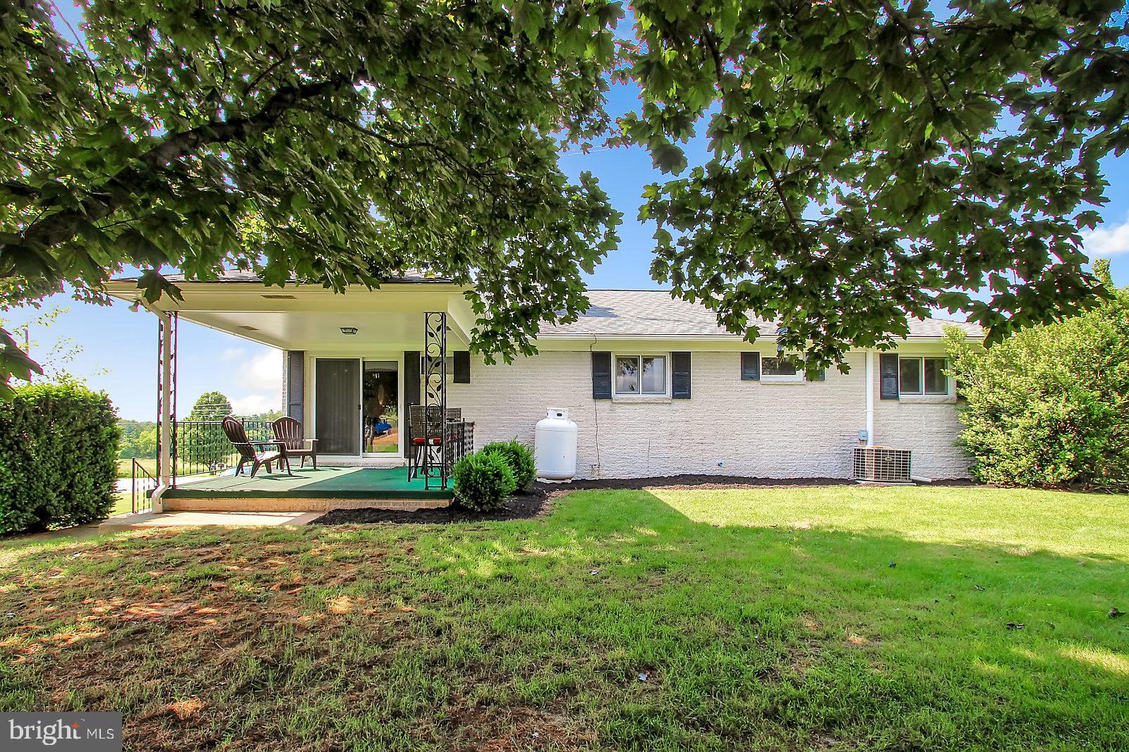 107 Bollinger Road Littlestown, PA 17340 - Photo 22 of 27 a front view of a house with a yard and trees