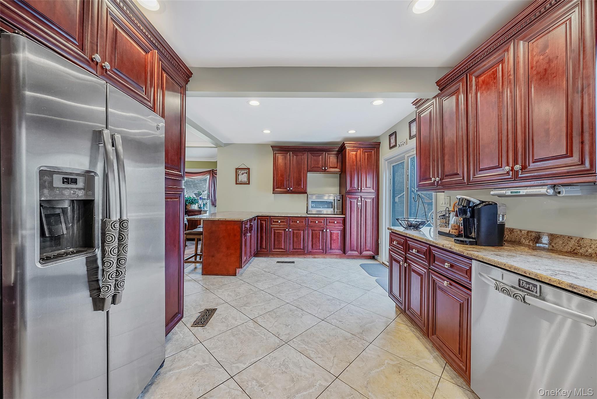 80 George Street Babylon, NY 11702 - Photo 13 of 41 a kitchen with stainless steel appliances granite countertop a refrigerator and a sink