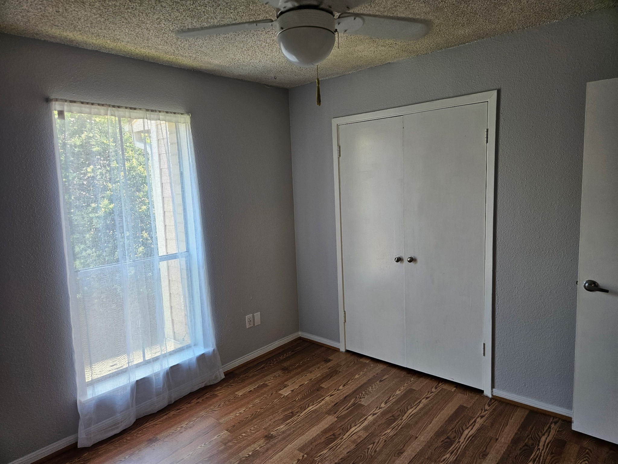 1505 Ward Road, Unit 112 Baytown, TX 77520 - Photo 14 of 15 a view of an empty room with wooden floor and a window