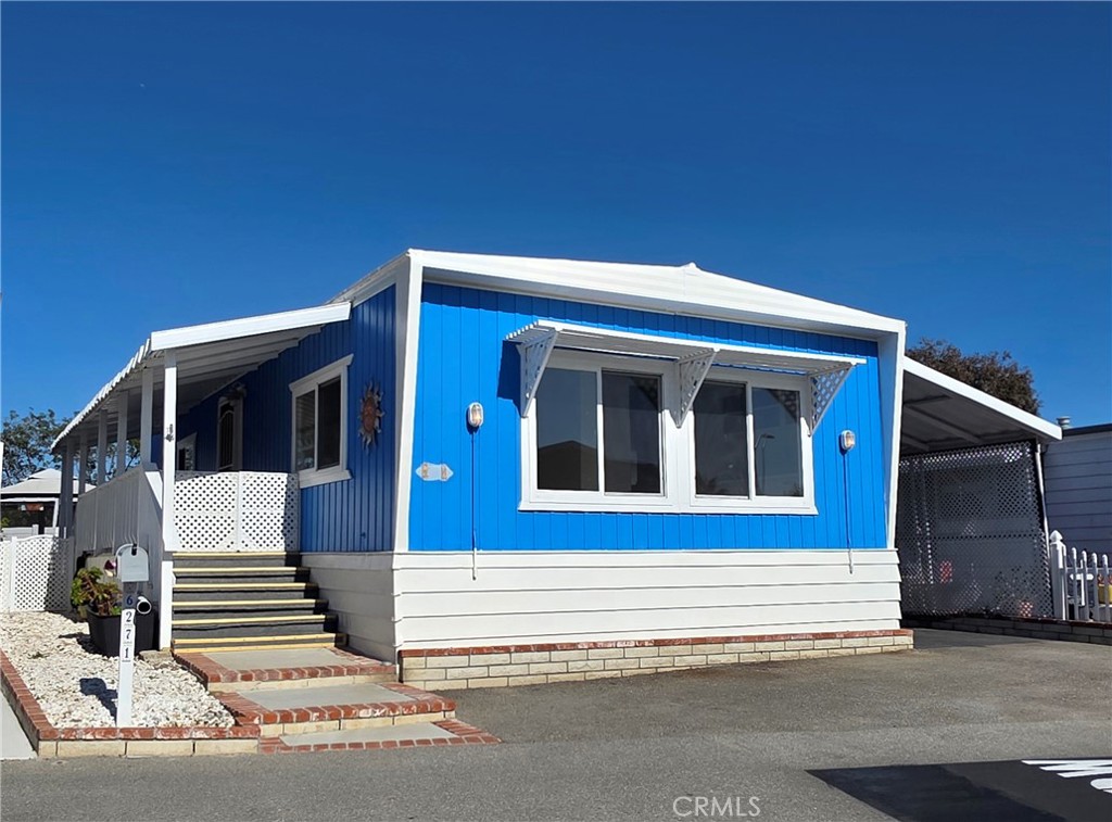 6271 East Sea Breeze Drive, Unit 36 Long Beach, CA 90803 - Photo 2 of 34 a front view of a house with a garage