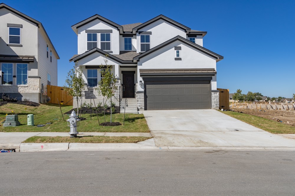 a front view of a house with a yard
