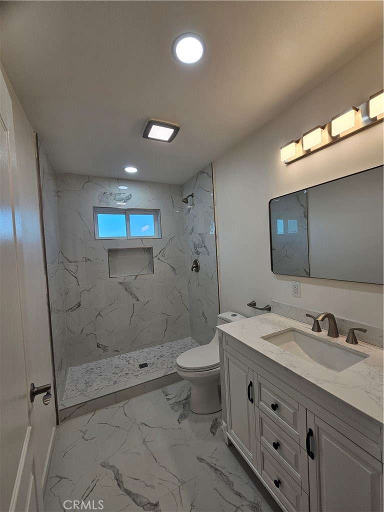 2641 Valley View Avenue Norco, CA 92860 - Photo 13 of 24 a bathroom with a sink a toilet and shower