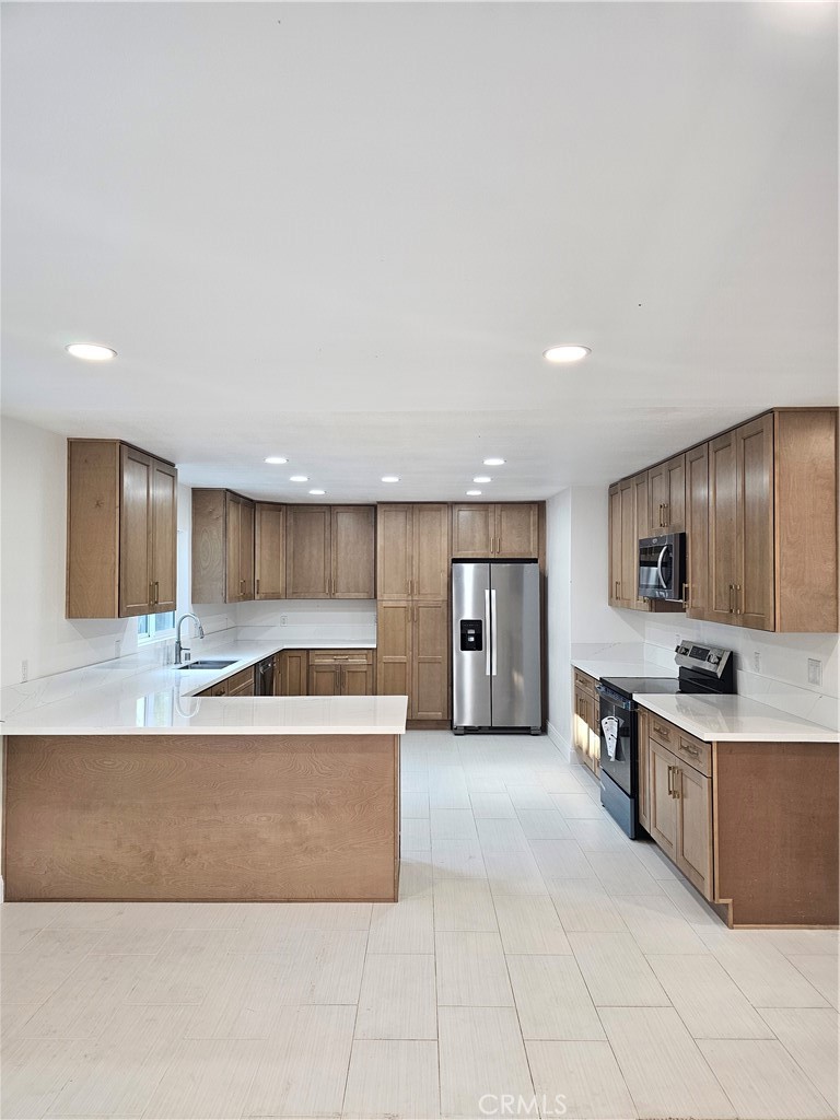 2641 Valley View Avenue Norco, CA 92860 - Photo 5 of 24 a large kitchen with kitchen island a sink a counter top space and cabinets