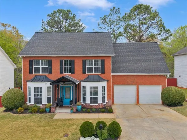 a front view of a house with a yard