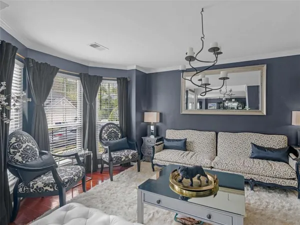 a dining room with furniture a chandelier and wooden floor