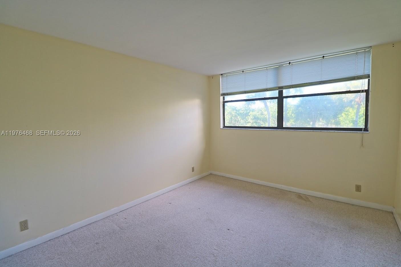 16500 Golf Club Road, Unit 205 Weston, FL 33326 - Photo 13 of 18 an empty room with windows