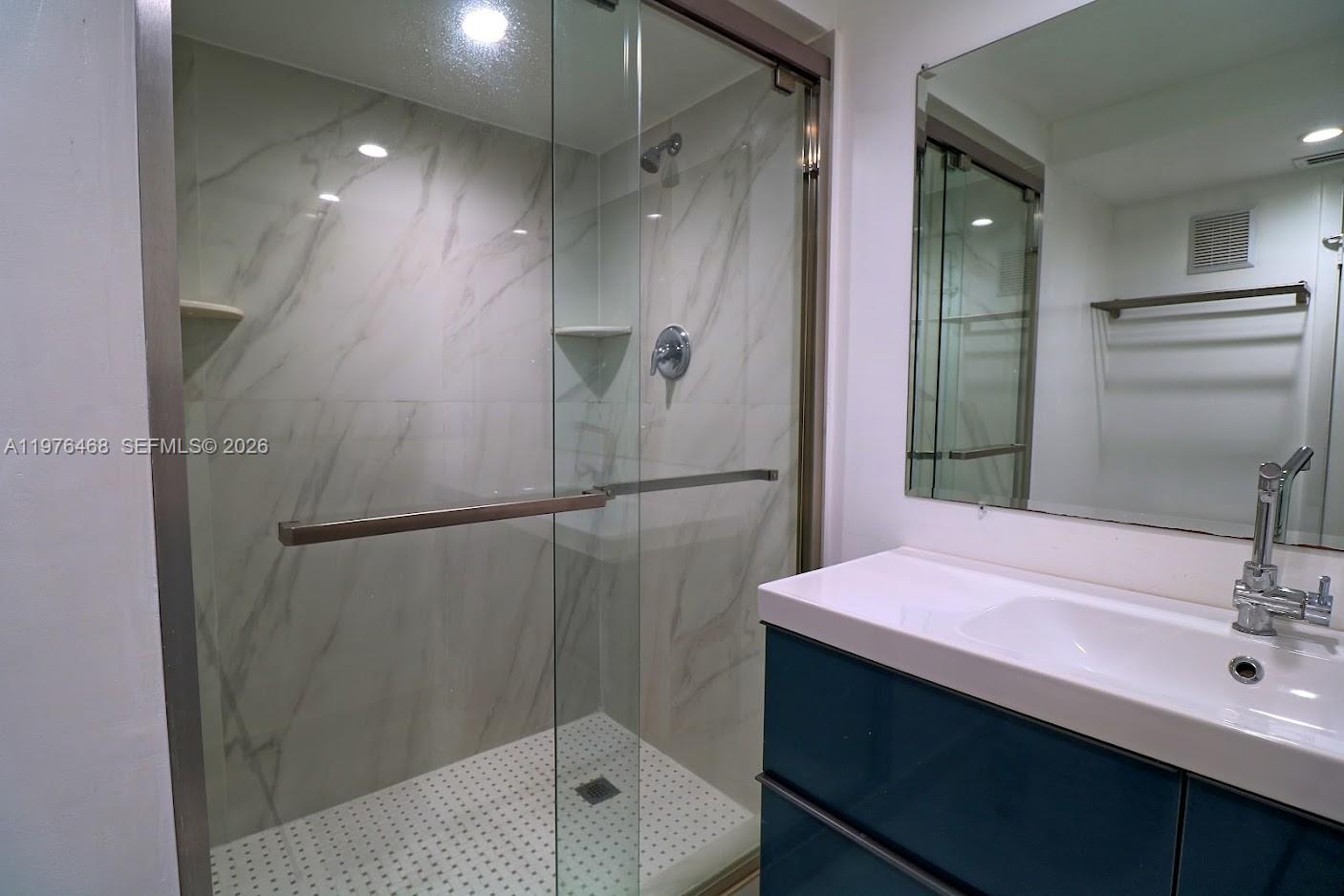 16500 Golf Club Road, Unit 205 Weston, FL 33326 - Photo 16 of 18 a bathroom with a sink shower and a mirror