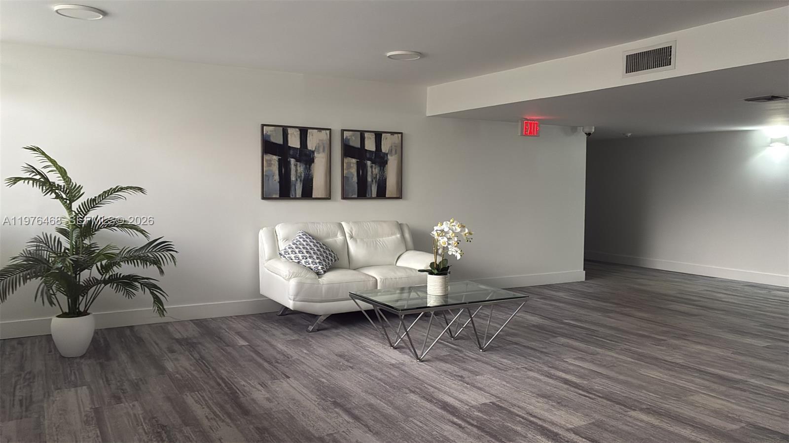 16500 Golf Club Road, Unit 205 Weston, FL 33326 - Photo 17 of 18 a living room with furniture and wooden floor