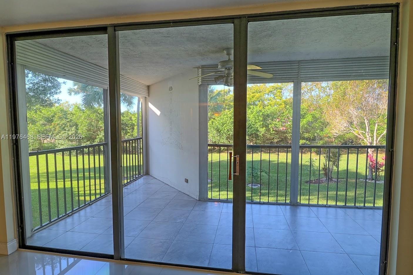 16500 Golf Club Road, Unit 205 Weston, FL 33326 - Photo 6 of 18 a view of an empty room with a floor to ceiling window