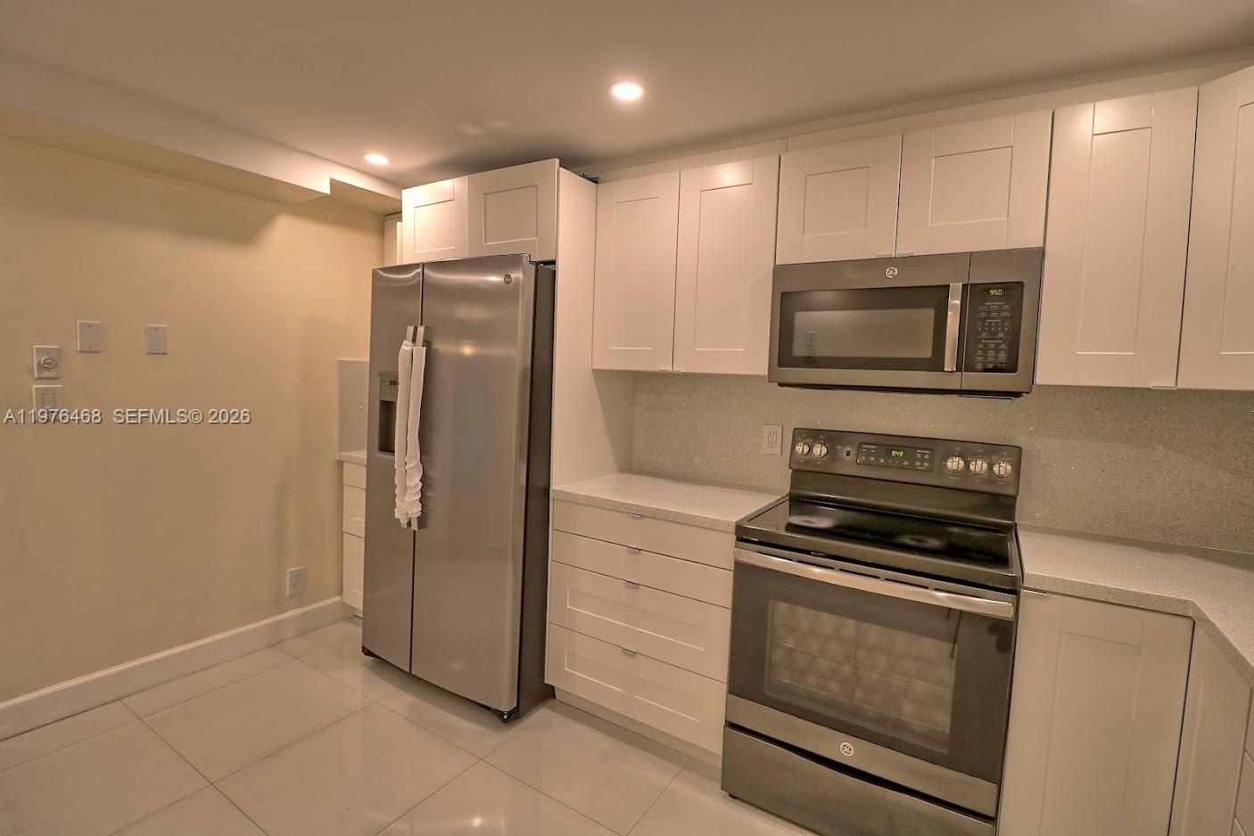 16500 Golf Club Road, Unit 205 Weston, FL 33326 - Photo 9 of 18 a kitchen with a refrigerator stove and microwave