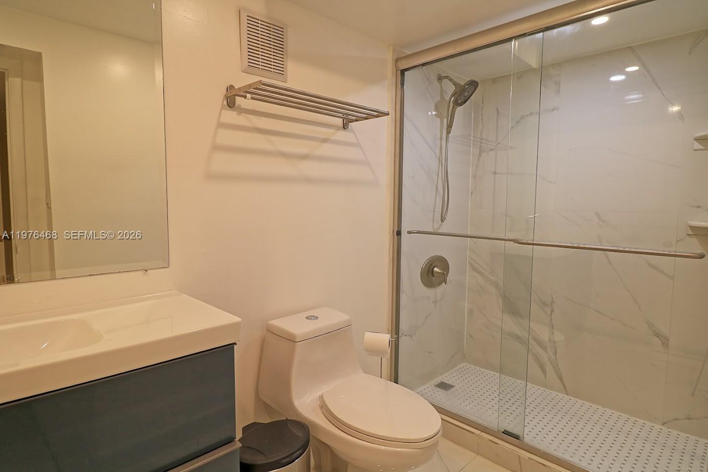 16500 Golf Club Road, Unit 205 Weston, FL 33326 - Photo 10 of 18 a bathroom with a shower a toilet and sink