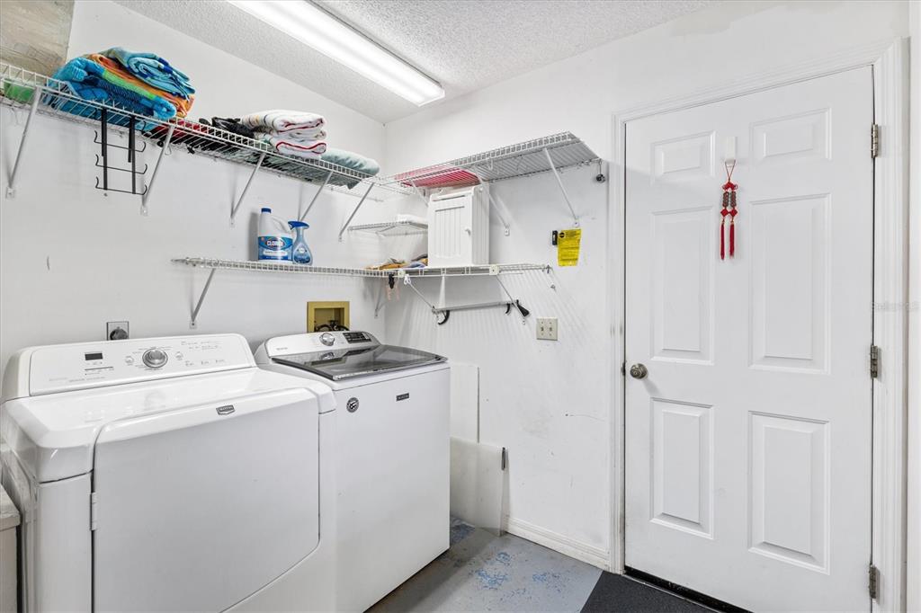 711 Agua Way Lady Lake, FL 32159 - Photo 13 of 16 a view of storage room with washer and dryer