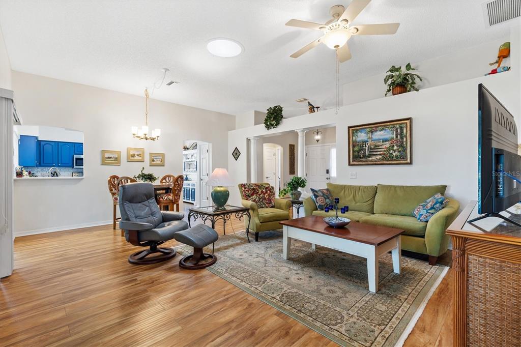 711 Agua Way Lady Lake, FL 32159 - Photo 4 of 16 a living room with furniture and wooden floor