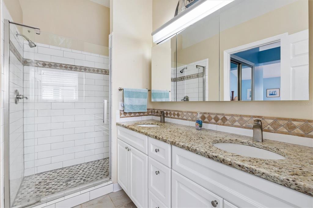 711 Agua Way Lady Lake, FL 32159 - Photo 9 of 16 a bathroom with a granite countertop sink and a mirror