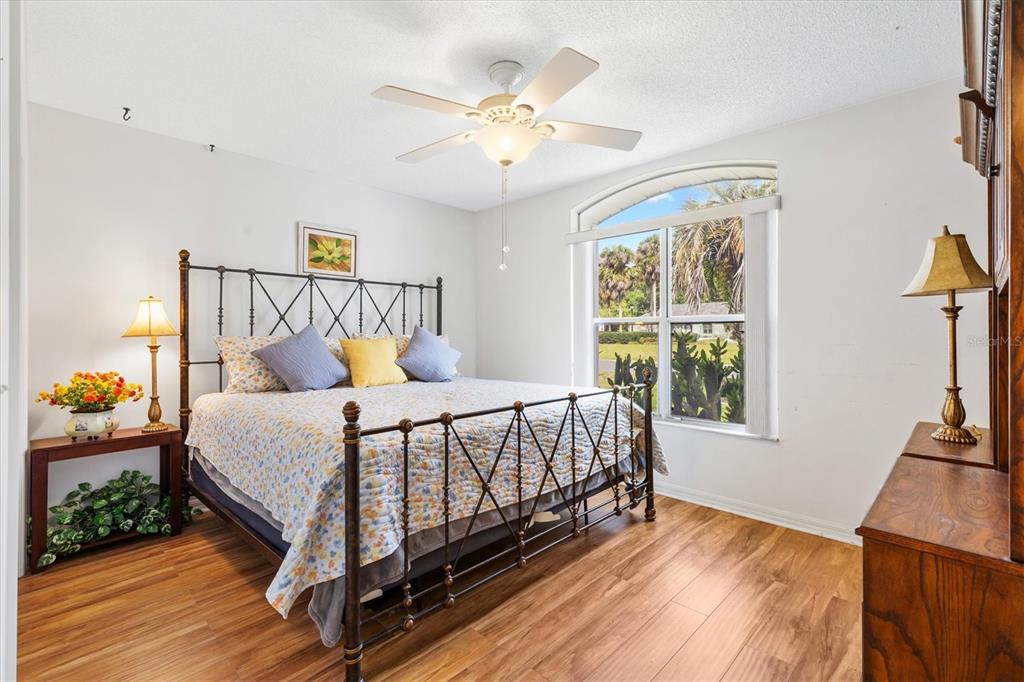 711 Agua Way Lady Lake, FL 32159 - Photo 10 of 16 a bed sitting in a bedroom next to a window