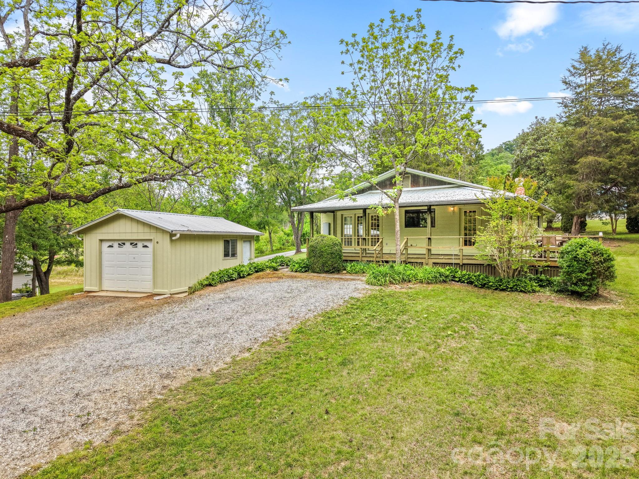 a front view of a house with a yard and trees