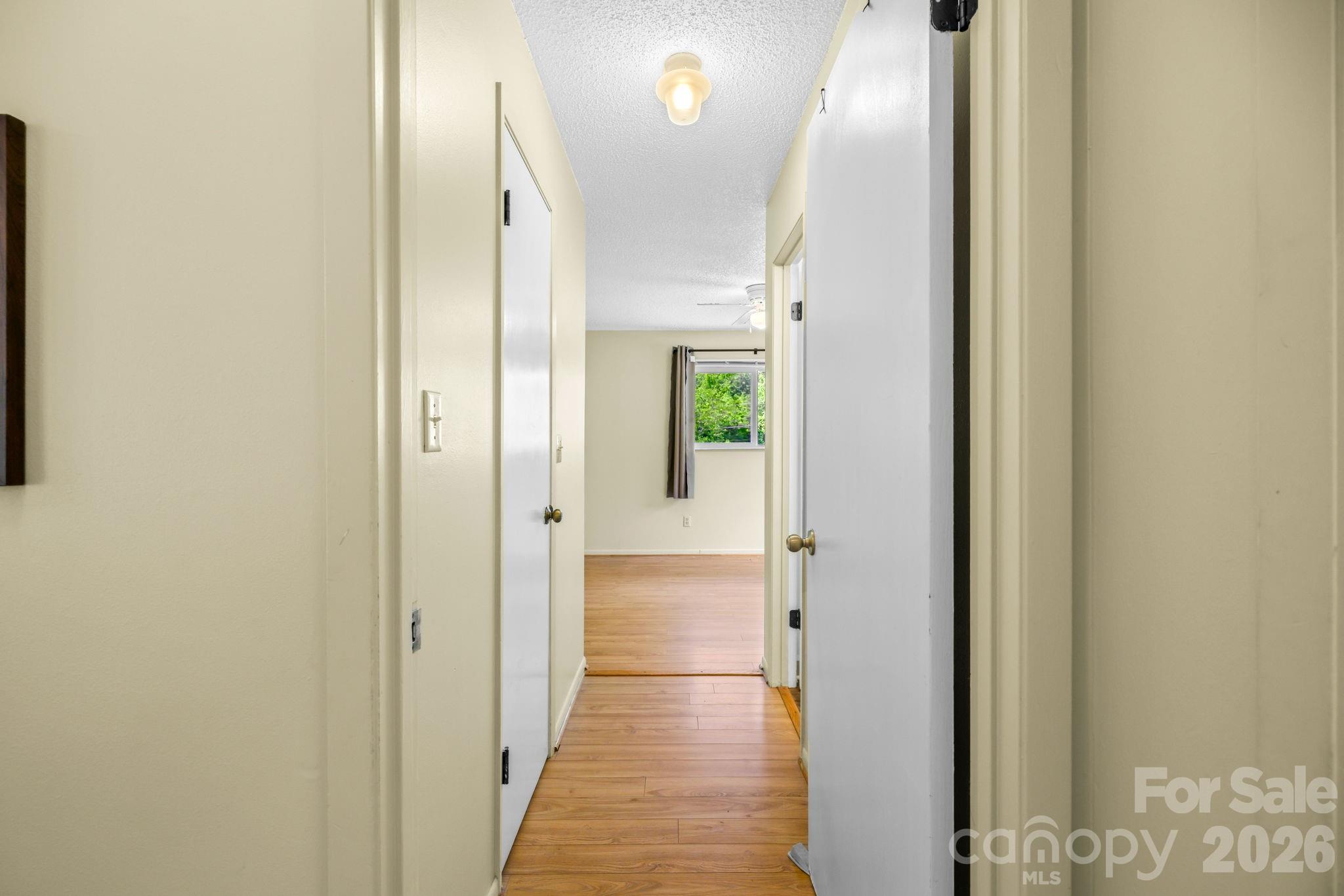 19 Quail Ridge Trail Franklin, NC 28734 - Photo 17 of 37 a view of a hallway with wooden floor and a bathroom