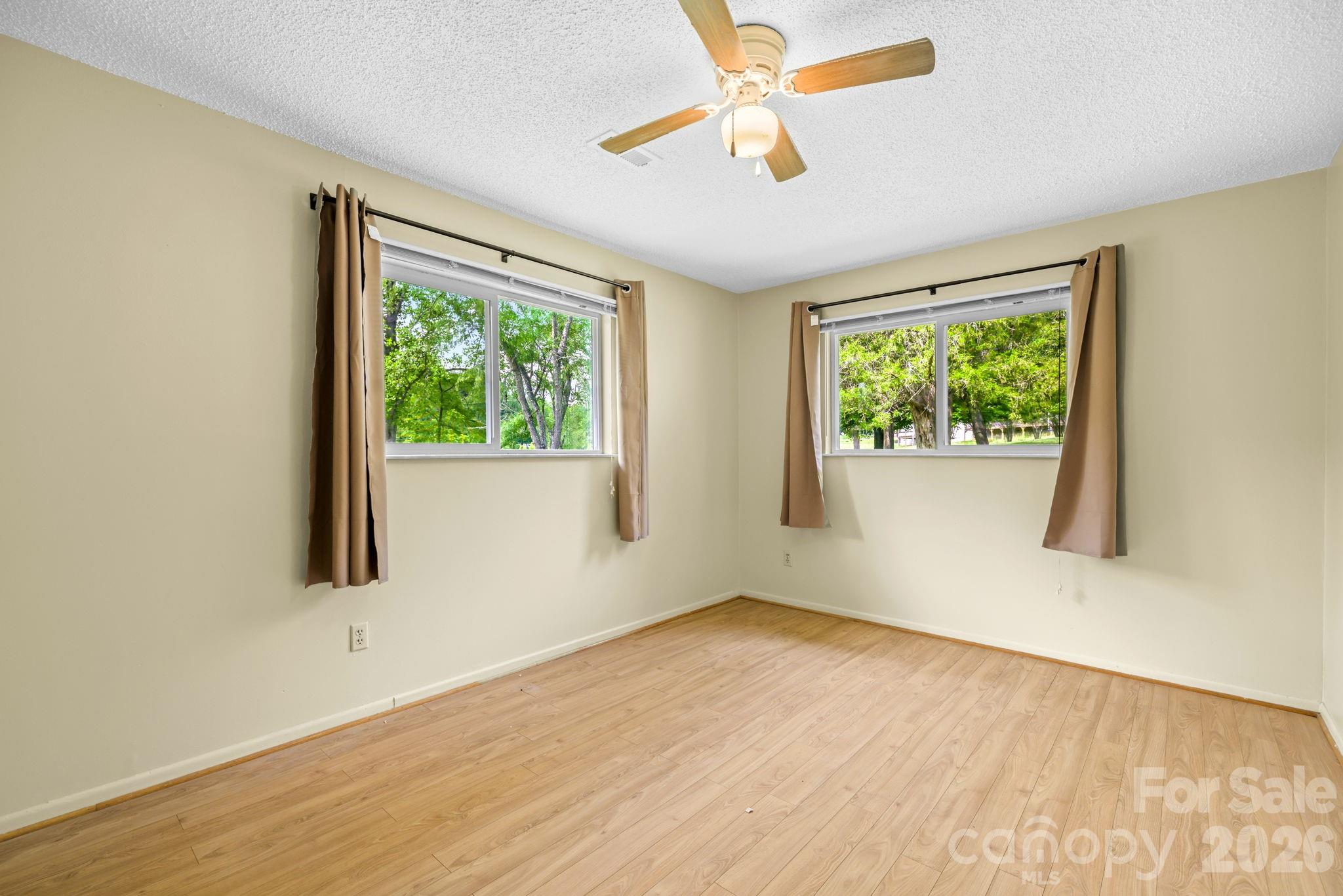 19 Quail Ridge Trail Franklin, NC 28734 - Photo 19 of 37 a view of an empty room with wooden floor and a window