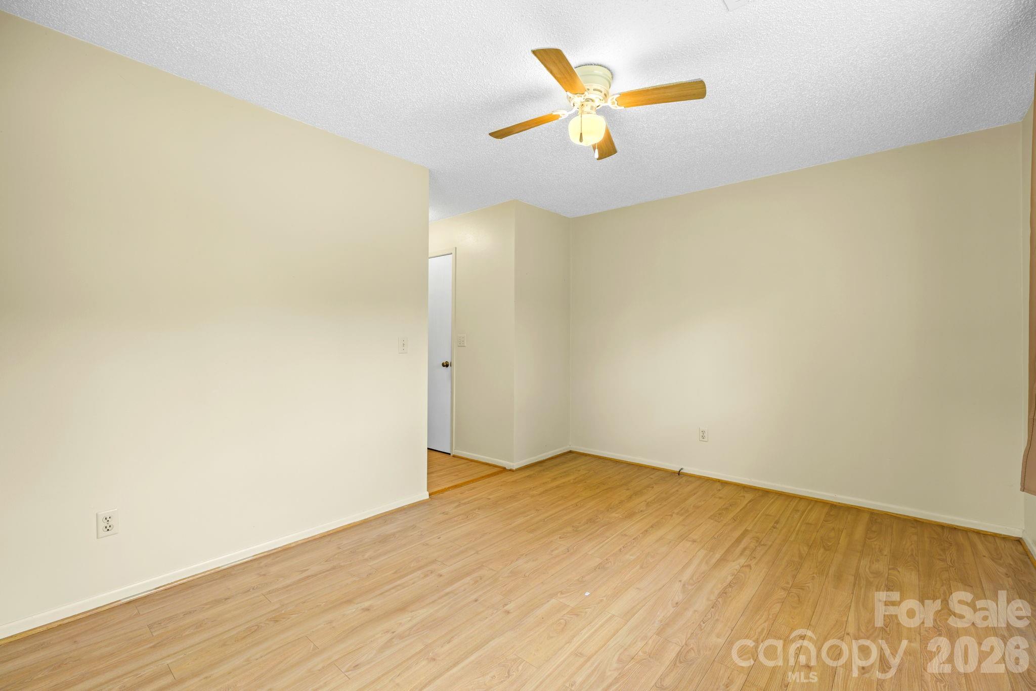 19 Quail Ridge Trail Franklin, NC 28734 - Photo 20 of 37 an empty room with a wooden floor and a window