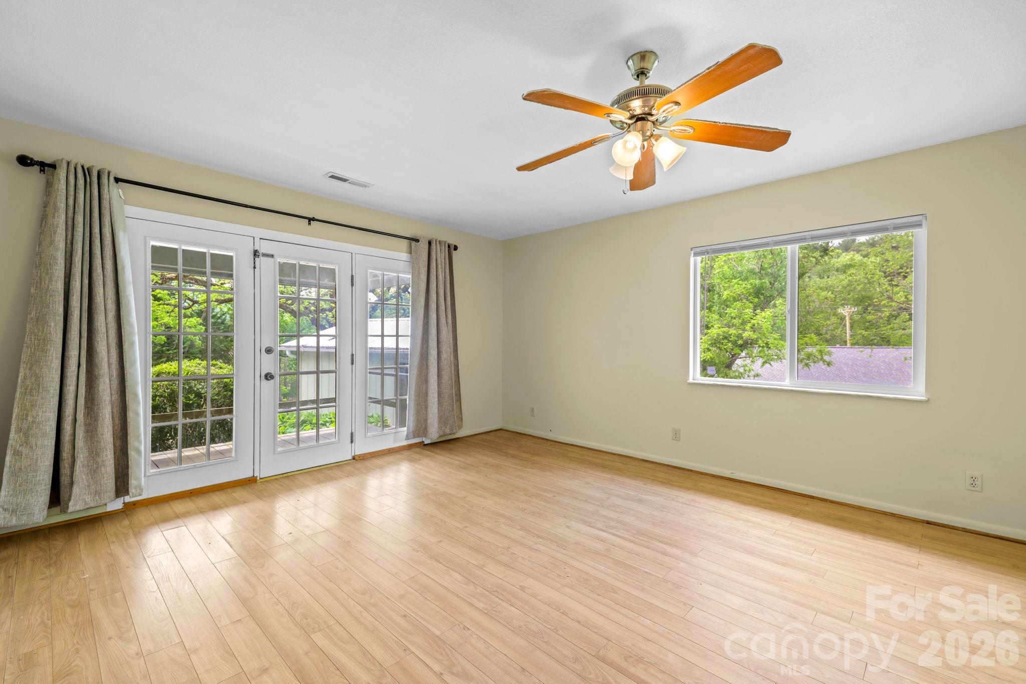 19 Quail Ridge Trail Franklin, NC 28734 - Photo 3 of 37 a view of an empty room with wooden floor and a window