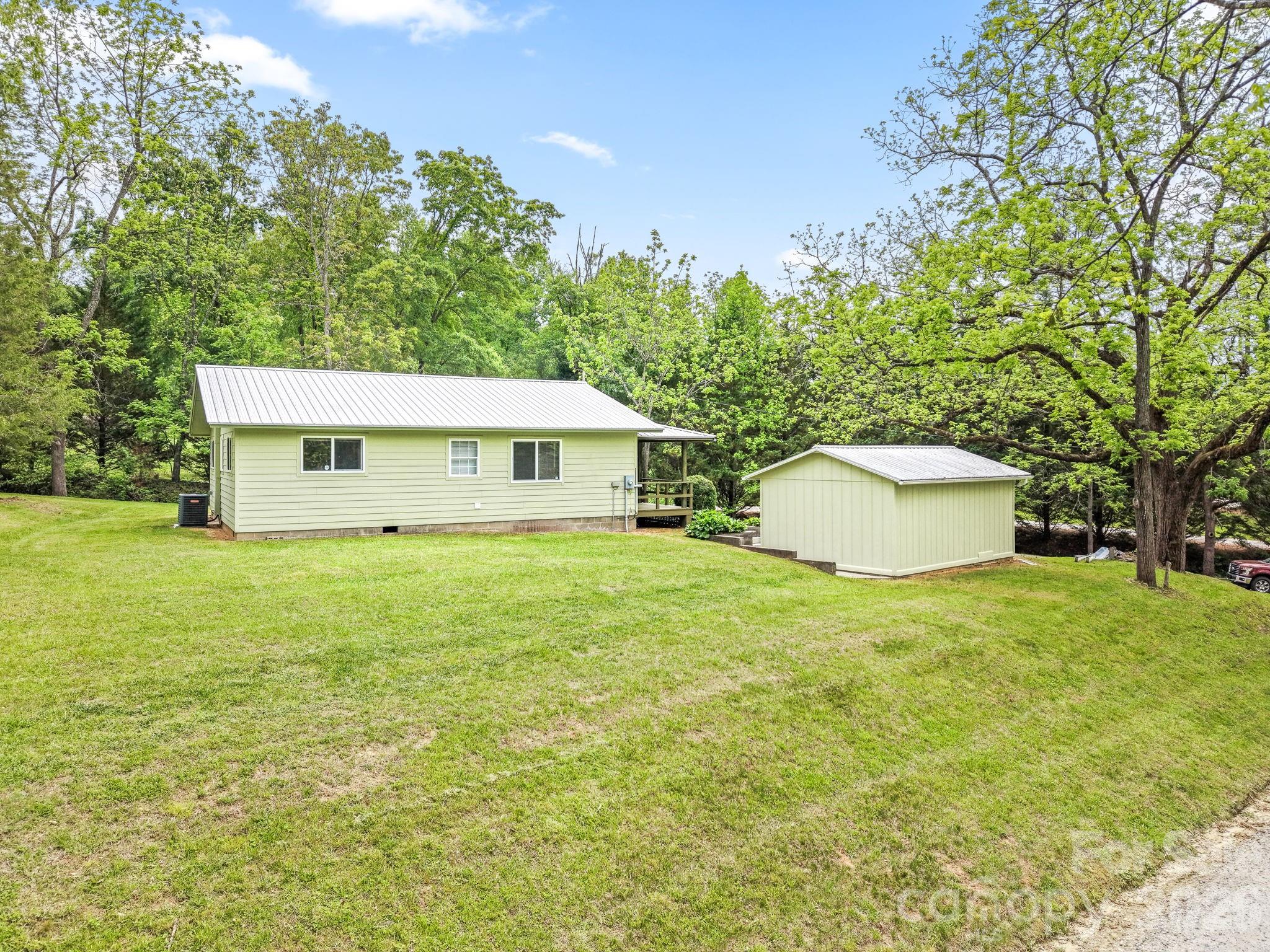 19 Quail Ridge Trail Franklin, NC 28734 - Photo 32 of 37 a view of a house with a backyard and a tree