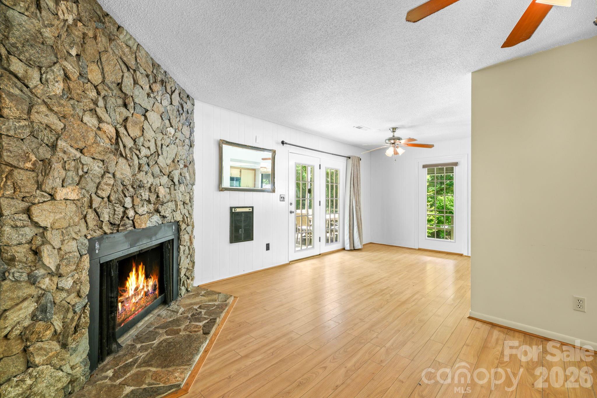 19 Quail Ridge Trail Franklin, NC 28734 - Photo 9 of 37 a view of an empty room with a fireplace and a window