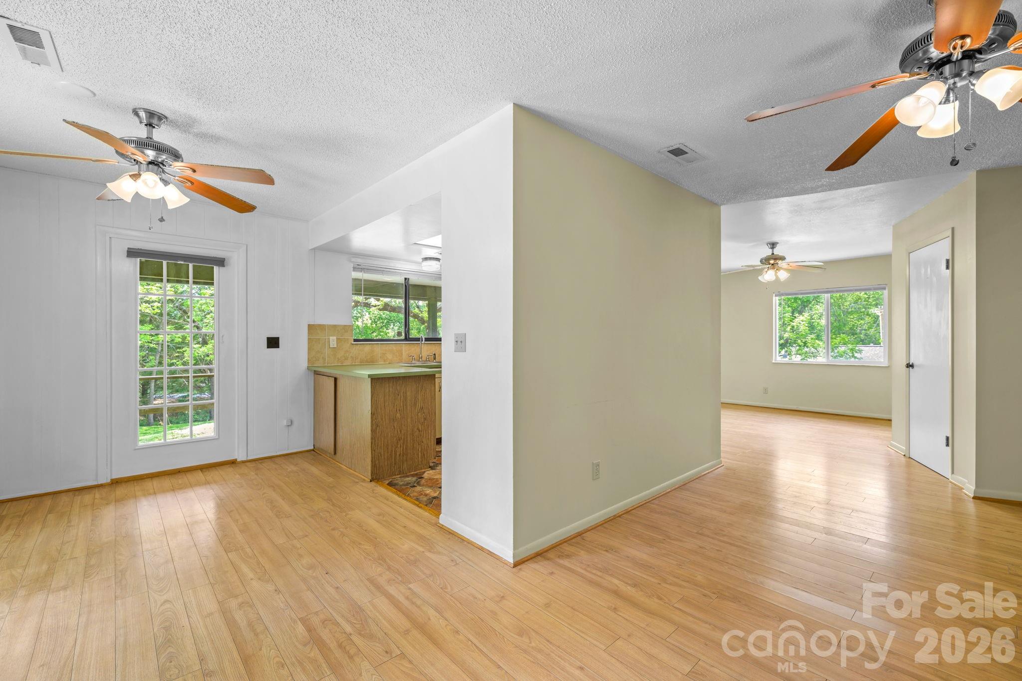 19 Quail Ridge Trail Franklin, NC 28734 - Photo 10 of 37 a view of an empty room with a window and wooden floor