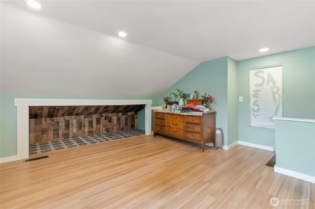 a view of a livingroom with wooden floor and a window