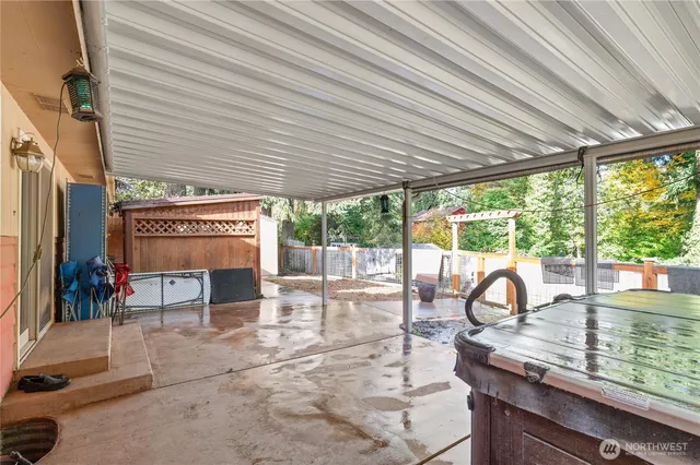 a view of a patio with table and chairs next to a yard